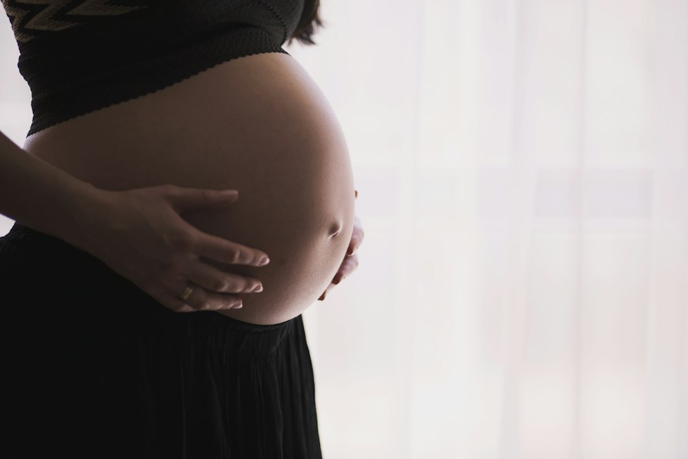 Expectant mother cradling her belly