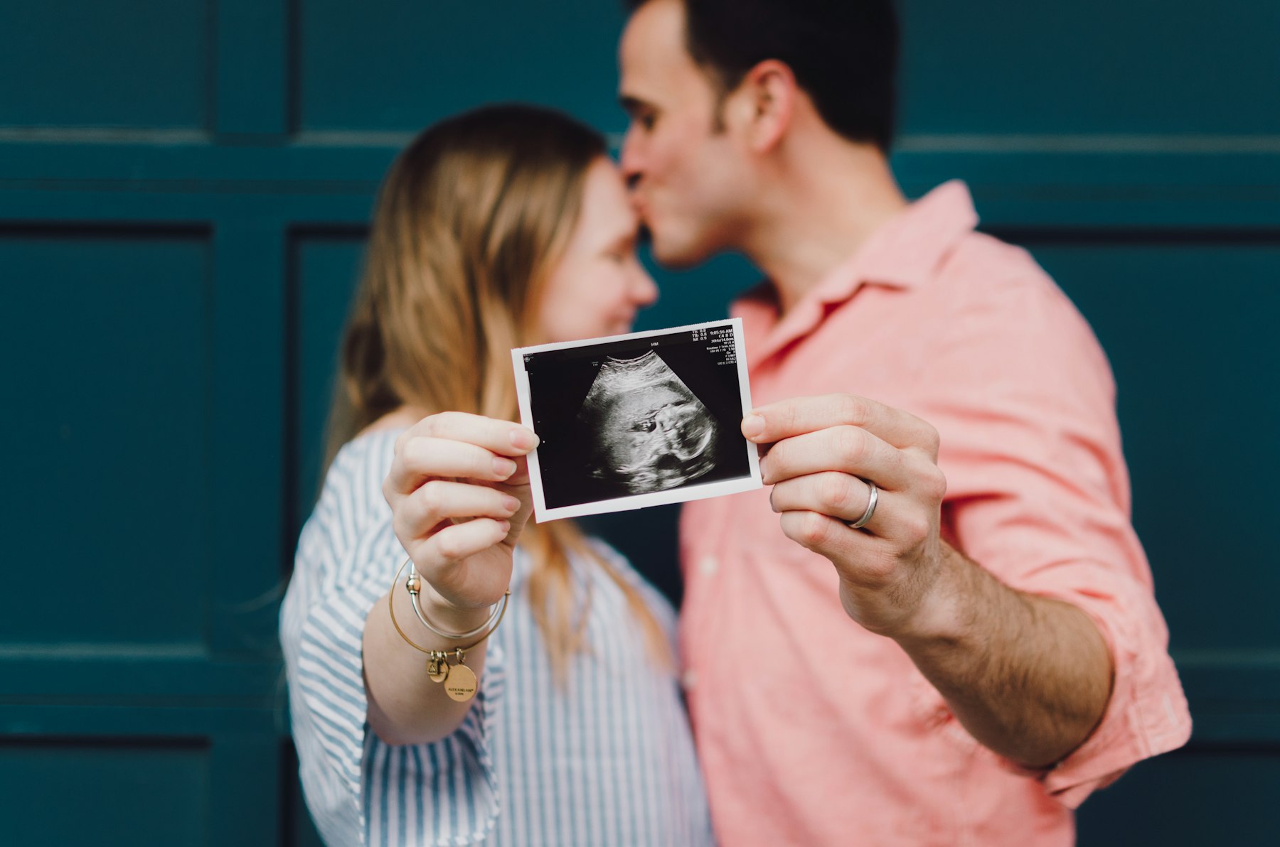 Couple holding their ultrasound photo