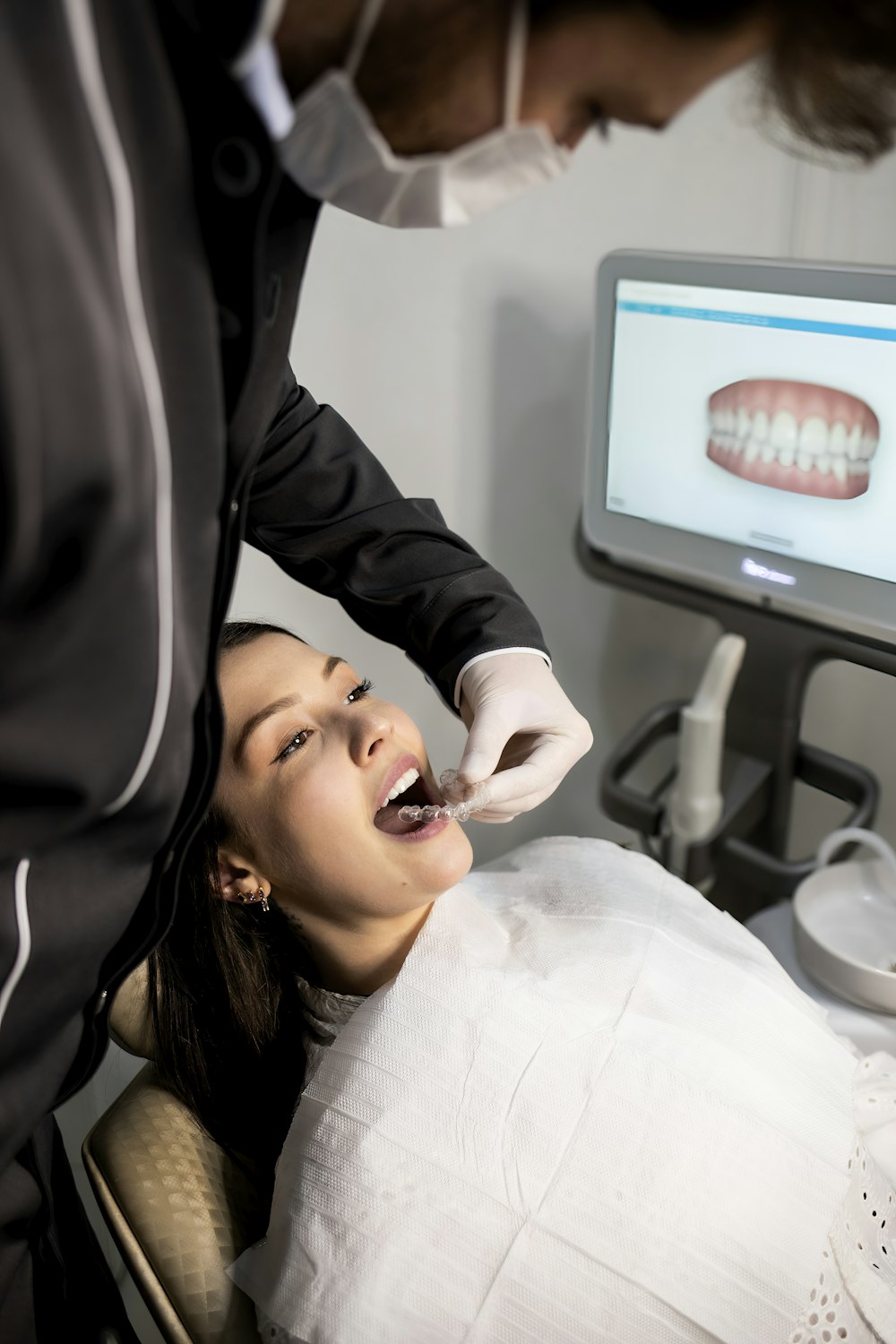 Dentist examining a patient with an intraoral scanner
